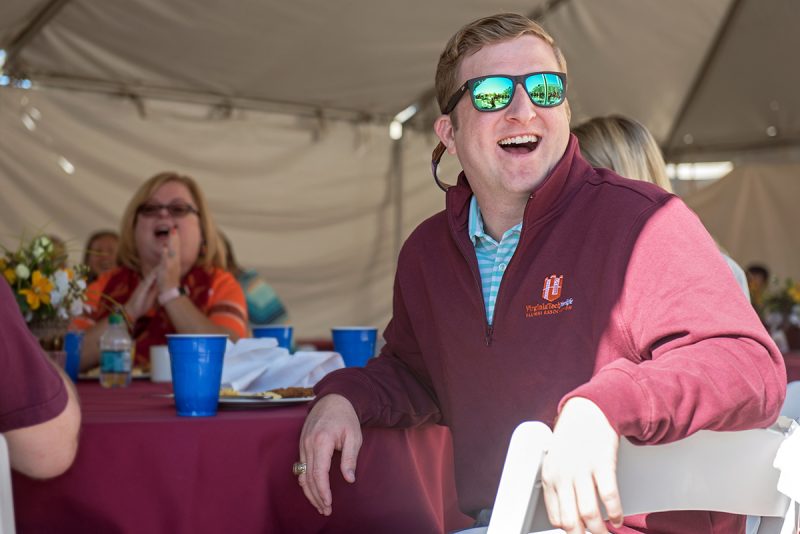 A Virginia Tech alum smiling at an event.