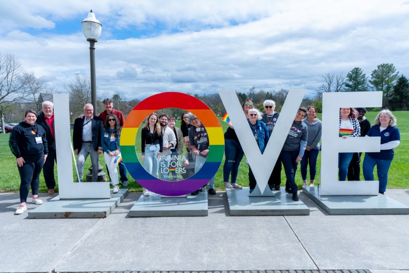 Hokie and Proud Weekend attendees with love sign