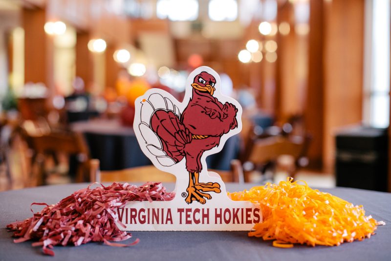 HokieBird table top sign with pom poms on a table in the Holtzman Alumni Center